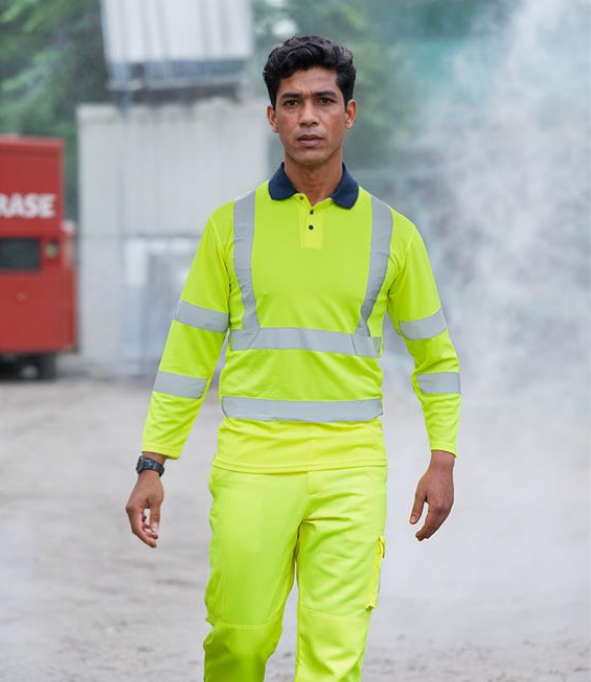 A person wearing a long sleeve hi-vis polo shirt in yellow with reflective bands and a contrast ribbed collar.